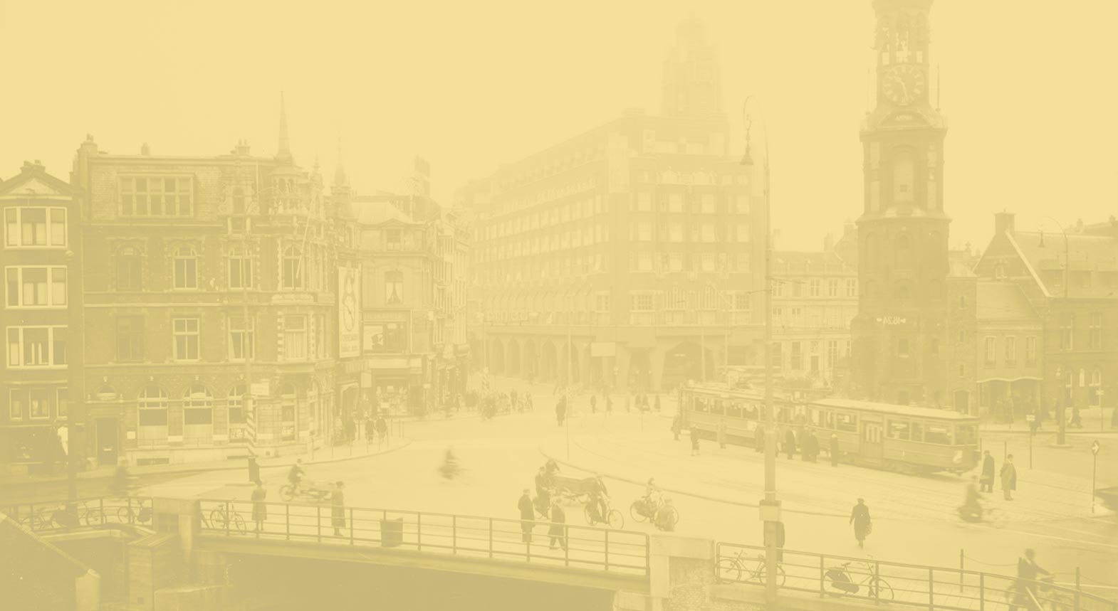 Yellow-tinted, grainy photograph of a city street with a tram in motion, pedestrians crossing the road, and buildings in the background